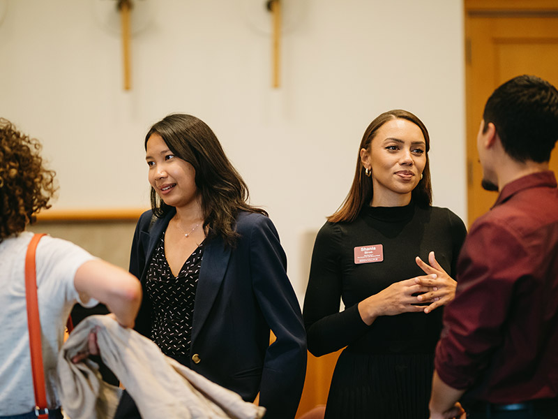 Center for Life Beyond Reed staff members talk with students at an event.