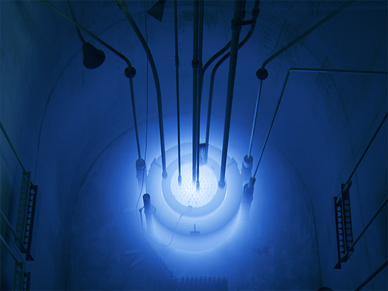 An image of the research reactor that shows the "blue glow" that is produced by charged particles in the core moving faster than the speed of light in water. 