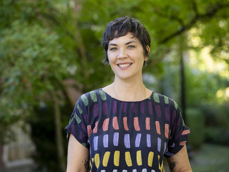 Photo portrait of Kate Duffly, Associate Professor of Theatre, standing outside with trees in the background.