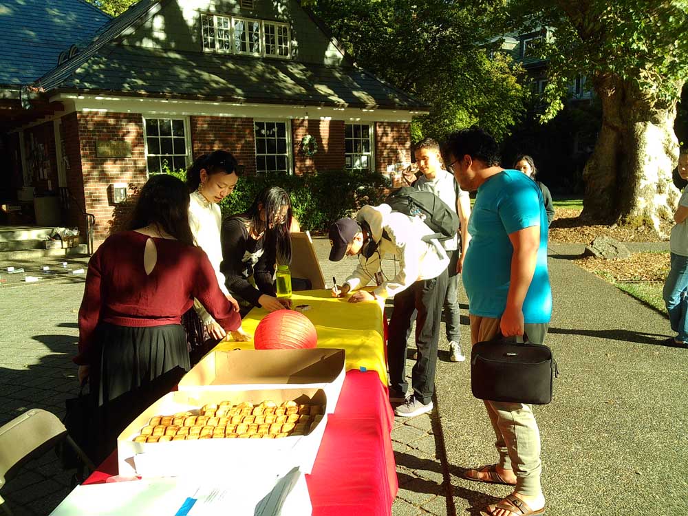 Students checking in at the registration table for the Mid-Autumn Festival