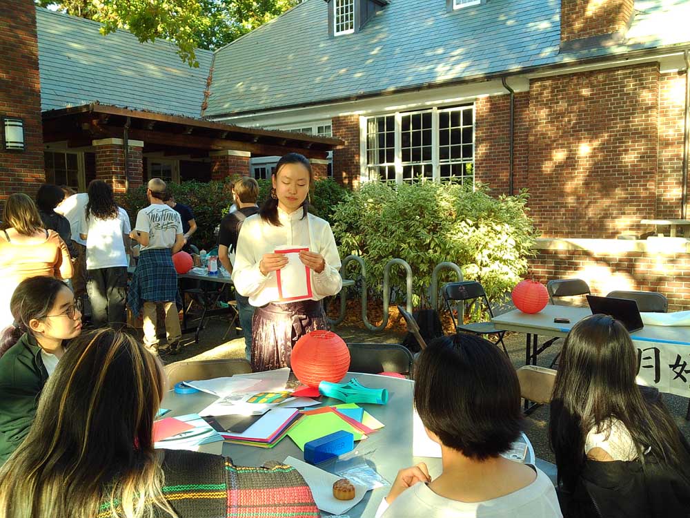 A student showing other how to make crafts with colorful paper