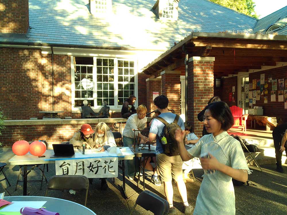 Attendees of the Mid-Autumn Festival inspecting Chinese arts and crafts