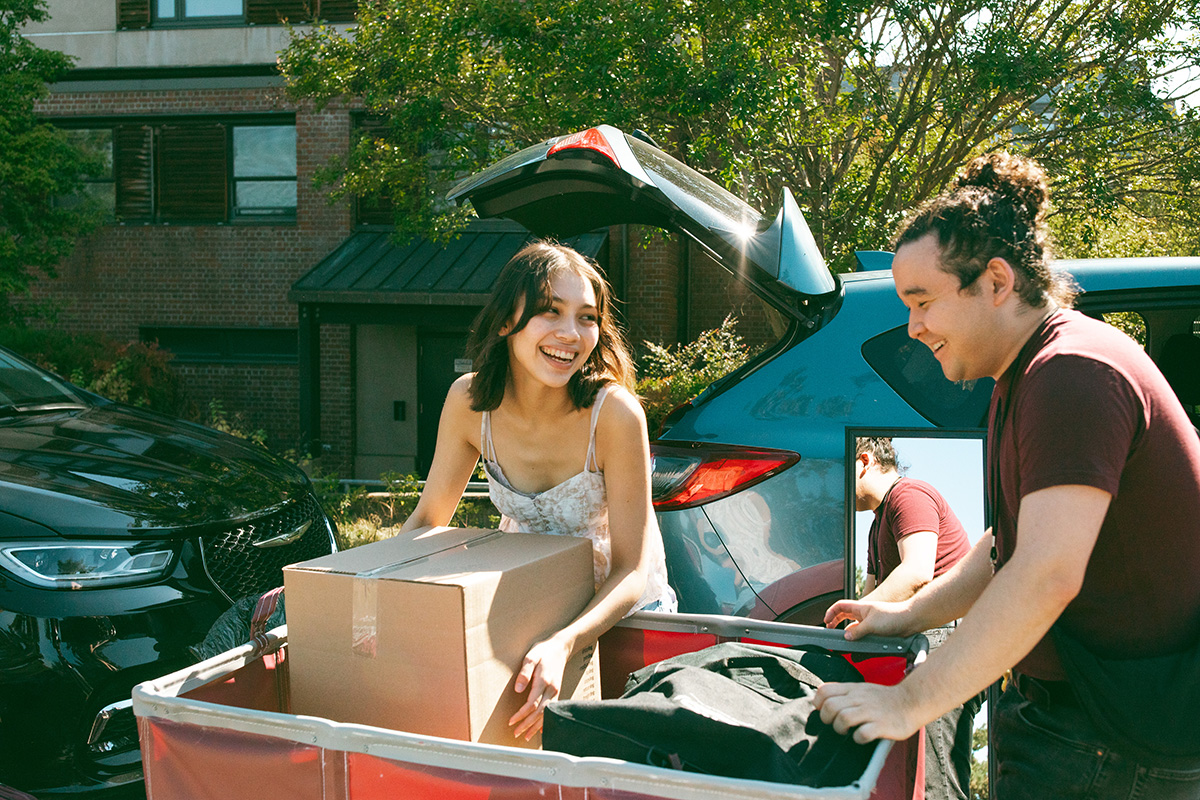 Siblings packing a push cart