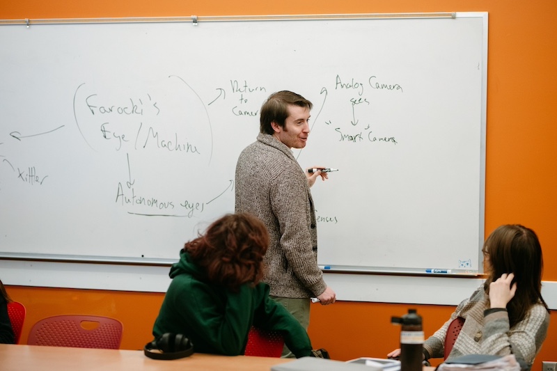 Professor of Film and Media Studies teaching in a classroom 