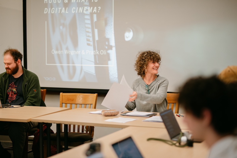 Professor of Film and Media Studies presenting in a classroom