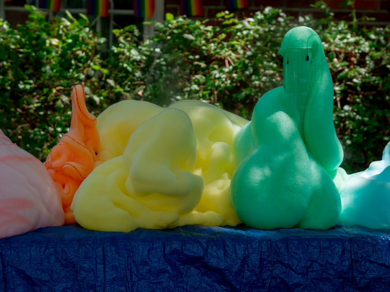 Colorful foam spilling out of beakers from a chemistry exhibit