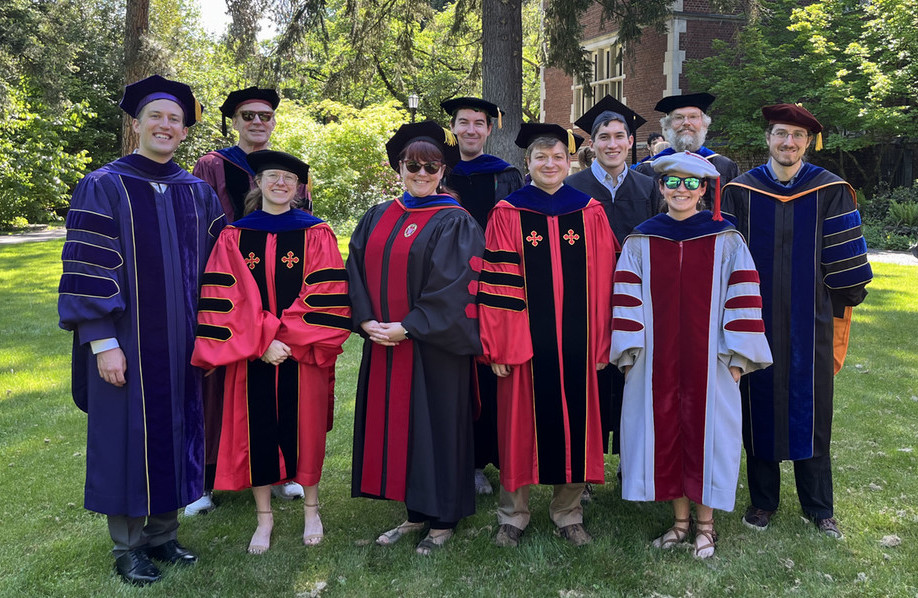 Math-stats and computer science faculty wearing robes pose for a group photo at graduation