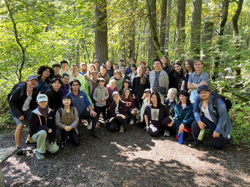 A group of students posing in a forest during a hike