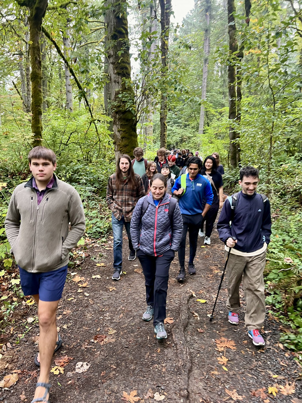 A group of students hiking through a forest