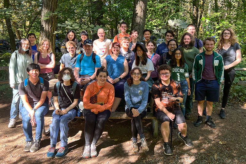 A large group of students posing for a photo during a hike.