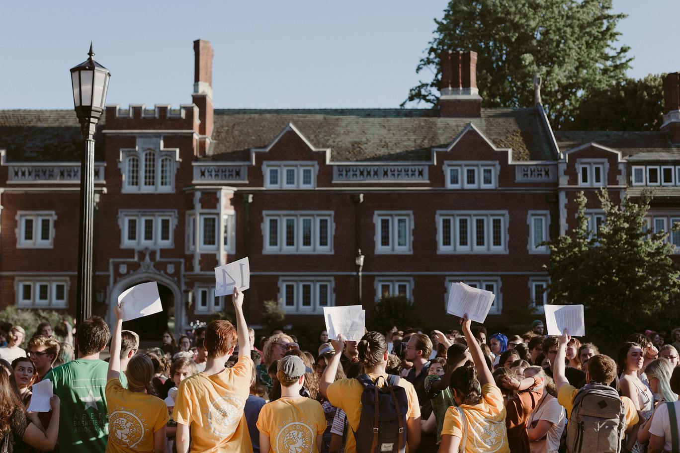 Student leaders at Reed orientation hold up group numbers for the new students in front of them