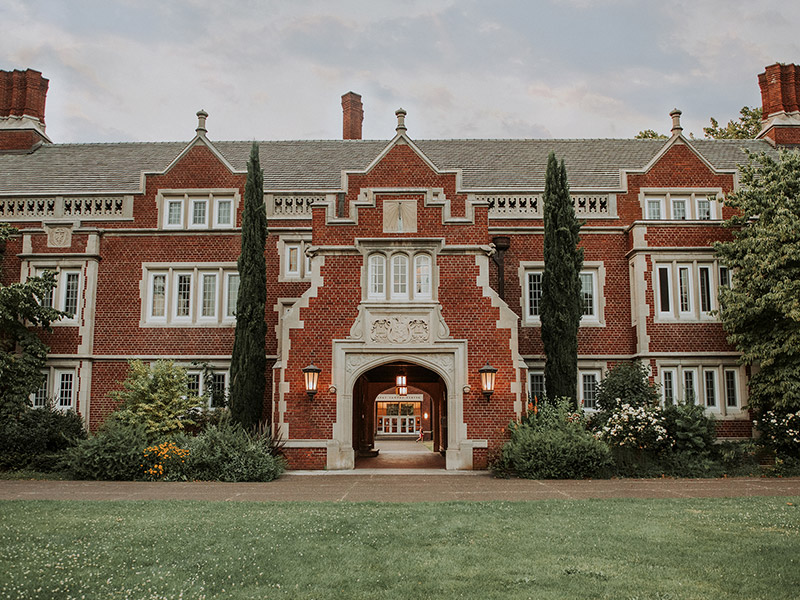 Old Dorm Block from the front lawn at dusk with a view of the quad through the sallyport.