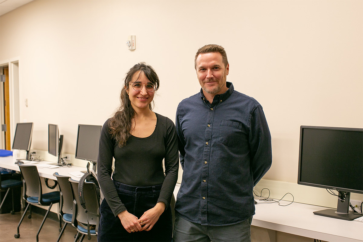 Two professors stand side by side in the Reed psychology building.