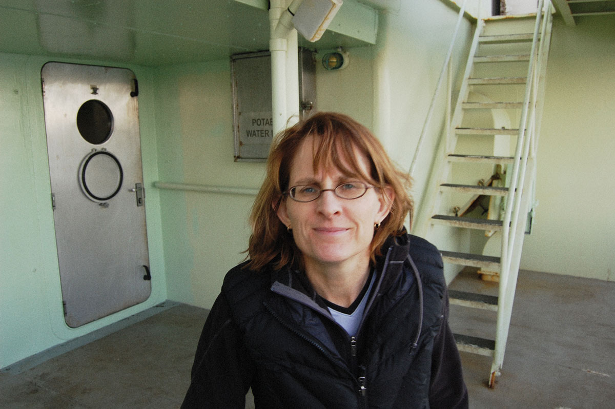 A closeup of Trish Quinn in the field on lower level of a large boat.